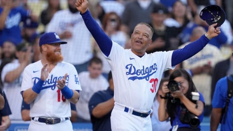 May 31, 2022; Los Angeles, California, USA; Los Angeles Dodgers manager Dave Roberts (30) is recognized for his 50th birthday as third baseman Justin Turner (10) watches during the game against the Pittsburgh Pirates  at Dodger Stadium. Mandatory Credit: Kirby Lee-USA TODAY Sports