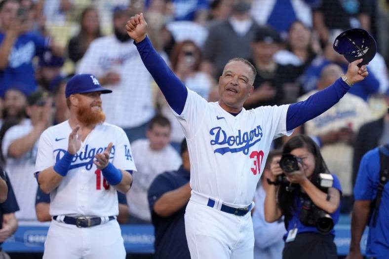 May 31, 2022; Los Angeles, California, USA; Los Angeles Dodgers manager Dave Roberts (30) is recognized for his 50th birthday as third baseman Justin Turner (10) watches during the game against the Pittsburgh Pirates
  at Dodger Stadium. Mandatory Credit: Kirby Lee-USA TODAY Sports