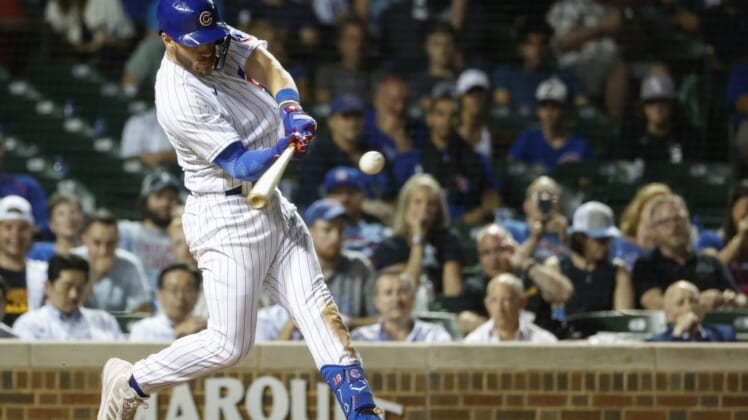 May 31, 2022; Chicago, Illinois, USA; Chicago Cubs third baseman Patrick Wisdom (16) hits a solo home run against the Milwaukee Brewers during the eight inning at Wrigley Field. Mandatory Credit: Kamil Krzaczynski-USA TODAY Sports
