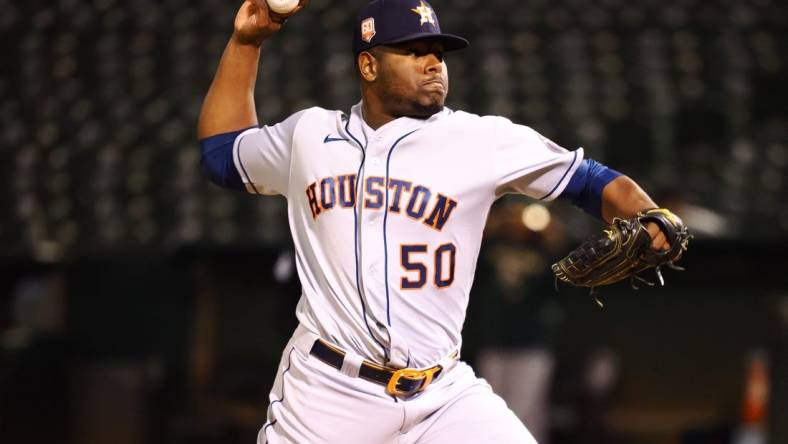 May 31, 2022; Oakland, California, USA; Houston Astros relief pitcher Hector Neris (50) pitches the ball against the Oakland Athletics during the eighth inning at RingCentral Coliseum. Mandatory Credit: Kelley L Cox-USA TODAY Sports