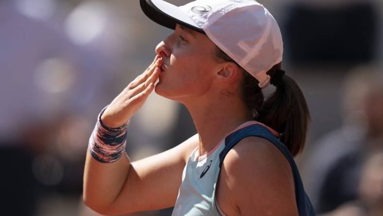 June 1, 2022; Paris, France; Iga Swiatek (POL) celebrates winning her match against Jessica Pegula (USA) on day 11 of the French Open at Stade Roland-Garros. Mandatory Credit: Susan Mullane-USA TODAY Sports