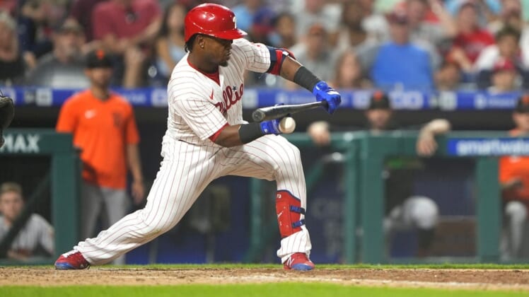 May 31, 2022; Philadelphia, Pennsylvania, USA; Philadelphia Phillies second baseman Jean Segura (2) breaks a finger attempting to bunt against the San Francisco Giants during the seventh inning at Citizens Bank Park. Mandatory Credit: Gregory Fisher-USA TODAY Sports