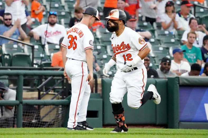 Jun 1, 2022; Baltimore, Maryland, USA; Baltimore Orioles second baseman Rougned Odor (12) is greeted by third base coach Tony Mansolino (36) following his three run home run in the second inning against the Seattle Mariners at Oriole Park at Camden Yards. Mandatory Credit: Mitch Stringer-USA TODAY Sports