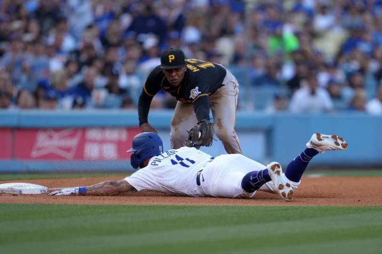 Jun 1, 2022; Los Angeles, California, USA; Los Angeles Dodgers left fielder Kevin Pillar (11) is tagged out at third base by Pittsburgh Pirates third baseman Ke'Bryan Hayes (13) in the third inning as umpire Nate Tomlinson makes the call at Dodger Stadium. Mandatory Credit: Kirby Lee-USA TODAY Sports