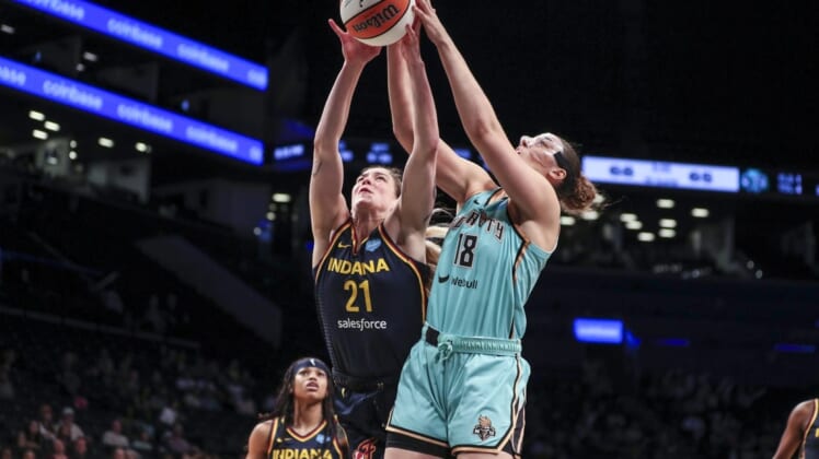 Jun 1, 2022; Brooklyn, New York, USA; Indiana Fever forward Emily Engstler (21) and New York Liberty forward Lorela Cubaj (18) fight for a rebound in the fourth quarter at Barclays Center. Mandatory Credit: Wendell Cruz-USA TODAY Sports