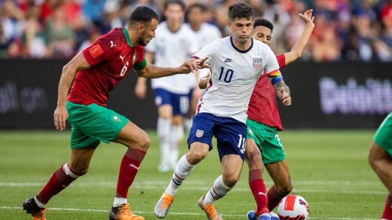 Jun 1, 2022; Cincinnati, Ohio, USA; United States forward Christian Pulisic (10) dribbles the ball while Morocco midfielder Imran Louza (7) defends during an International friendly soccer match at TQL Stadium. Mandatory Credit: Trevor Ruszkowski-USA TODAY Sports