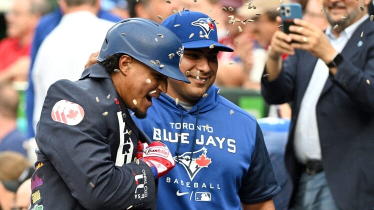 Jun 1, 2022; Toronto, Ontario, CAN; Toronto Blue Jays second baseman Santiago Espinal (5) is greeted by hitting coach Guillermo Martinez (18) after hitting a home run against the Chicago White Sox in the first inning at Rogers Centre. Mandatory Credit: Dan Hamilton-USA TODAY Sports