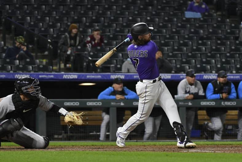 Jun 1, 2022; Denver, Colorado, USA; Colorado Rockies second baseman Brendan Rodgers (7) hits a two-run walk off home run in the bottom of the 10th against the Miami Marlins at Coors Field. Mandatory Credit: John Leyba-USA TODAY Sports