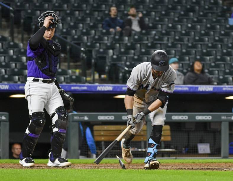 Jun 1, 2022; Denver, Colorado, USA; Colorado Rockies catcher Brian Serven (6) looks on as Miami Marlins third baseman Jon Berti (5) slams his bat on the ground and breaking it after flying out during the ninth inning at Coors Field. Mandatory Credit: John Leyba-USA TODAY Sports