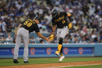 Jun 1, 2022; Los Angeles, California, USA; Pittsburgh Pirates shortstop Rodolfo Castro (14) celebrates with third base coach Mike Rabelo (58) after hitting a two-run home run in the eighth inning against the Los Angeles Dodgers at Dodger Stadium. Mandatory Credit: Kirby Lee-USA TODAY Sports