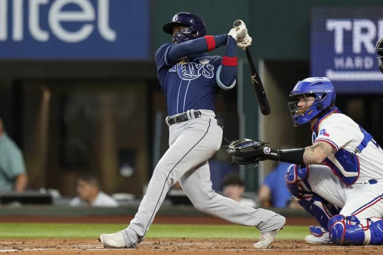 Jun 2, 2022; Arlington, Texas, USA; Tampa Bay Rays shortstop Vidal Brujan (7) follows through on his ground rule double against the Texas Rangers during the second inning at Globe Life Field. Mandatory Credit: Jim Cowsert-USA TODAY Sports
