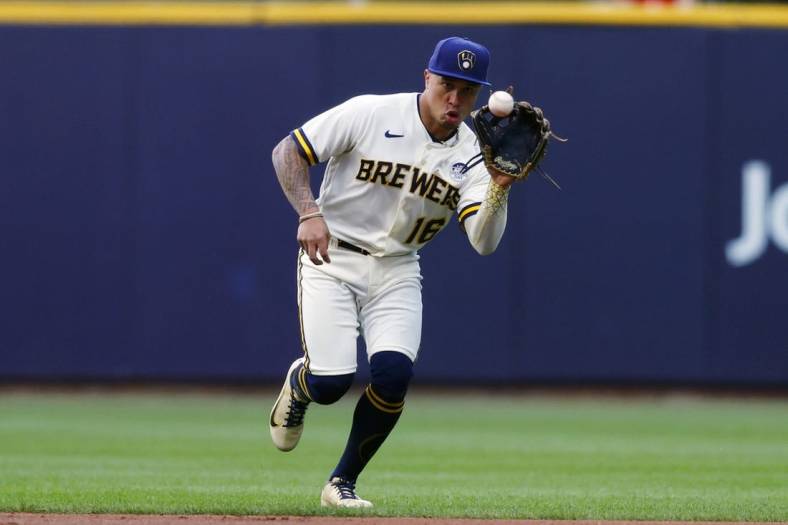 Jun 2, 2022; Milwaukee, Wisconsin, USA;  Milwaukee Brewers second baseman Kolten Wong (16) fields a ground ball during the first inning against the San Diego Padres at American Family Field. Mandatory Credit: Jeff Hanisch-USA TODAY Sports