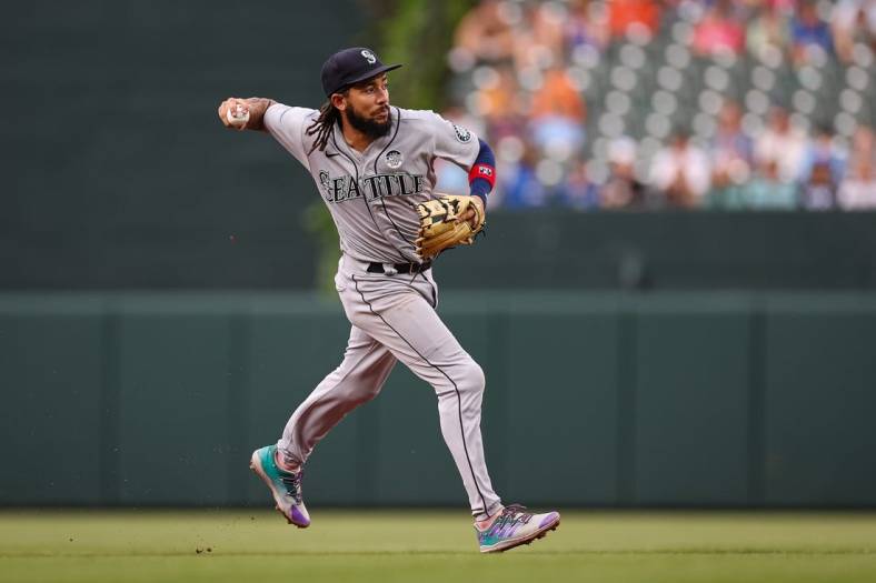 Jun 2, 2022; Baltimore, Maryland, USA; Seattle Mariners shortstop J.P. Crawford (3) makes a throw to first base against the Baltimore Orioles during the second inning at Oriole Park at Camden Yards. Mandatory Credit: Scott Taetsch-USA TODAY Sports