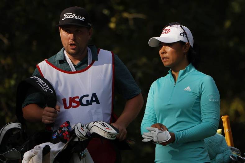 Jun 2, 2022; Southern Pines, North Carolina, USA; Danielle Kang (R) talks with her caddie (L) prior to hitting her tee shot on the twelfth hole during the first round of the U.S. Women's Open. Mandatory Credit: Geoff Burke-USA TODAY Sports