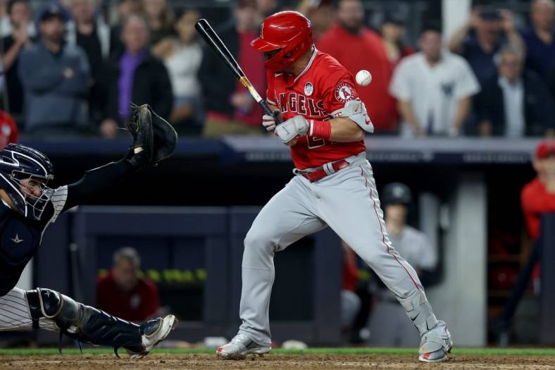 Jun 2, 2022; Bronx, New York, USA; Los Angeles Angels center fielder Mike Trout (27) is hit by a pitch during the ninth inning against the New York Yankees at Yankee Stadium. Mandatory Credit: Brad Penner-USA TODAY Sports