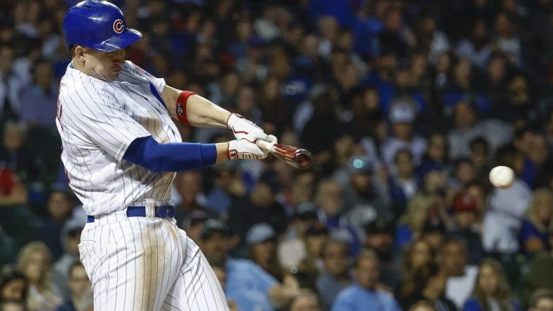 Jun 2, 2022; Chicago, Illinois, USA; Chicago Cubs first baseman Frank Schwindel (18) singles against the St. Louis Cardinals during the fifth inning at Wrigley Field. Mandatory Credit: Kamil Krzaczynski-USA TODAY Sports