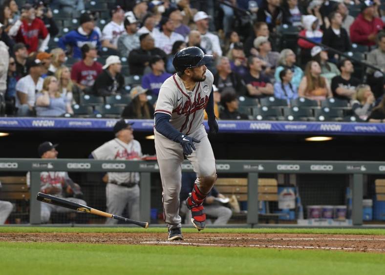 Jun 2, 2022; Denver, Colorado, USA; Atlanta Braves catcher Travis d'Arnaud (16) hits a grand slam in the fifth inning against the Colorado Rockies at Coors Field. Mandatory Credit: John Leyba-USA TODAY Sports