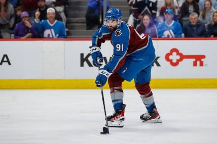 Jun 2, 2022; Denver, Colorado, USA; Colorado Avalanche center Nazem Kadri (91) controls the puck in the second period against the Edmonton Oilers in game two of the Western Conference Final of the 2022 Stanley Cup Playoffs at Ball Arena. Mandatory Credit: Isaiah J. Downing-USA TODAY Sports