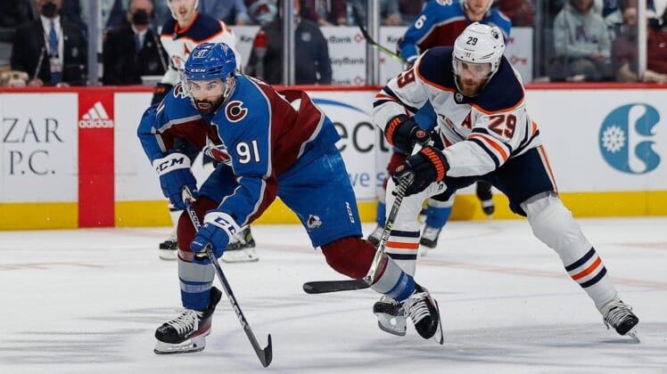 Jun 2, 2022; Denver, Colorado, USA; Colorado Avalanche center Nazem Kadri (91) controls the puck under pressure from Edmonton Oilers center Leon Draisaitl (29) in the second period in game two of the Western Conference Final of the 2022 Stanley Cup Playoffs at Ball Arena. Mandatory Credit: Isaiah J. Downing-USA TODAY Sports