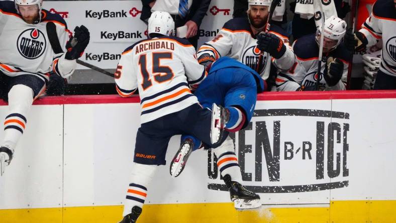 Jun 2, 2022; Denver, Colorado, USA; Edmonton Oilers right wing Zack Kassian (44) pulls the helmet off of Colorado Avalanche defenseman Bowen Byram (4) after a check by right wing Josh Archibald (15) in the third period of game two of the Western Conference Final of the 2022 Stanley Cup Playoffs at Ball Arena. Mandatory Credit: Ron Chenoy-USA TODAY Sports