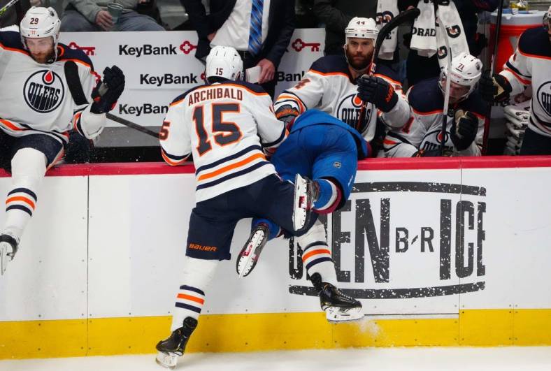 Jun 2, 2022; Denver, Colorado, USA; Edmonton Oilers right wing Zack Kassian (44) pulls the helmet off of Colorado Avalanche defenseman Bowen Byram (4) after a check by right wing Josh Archibald (15) in the third period of game two of the Western Conference Final of the 2022 Stanley Cup Playoffs at Ball Arena. Mandatory Credit: Ron Chenoy-USA TODAY Sports