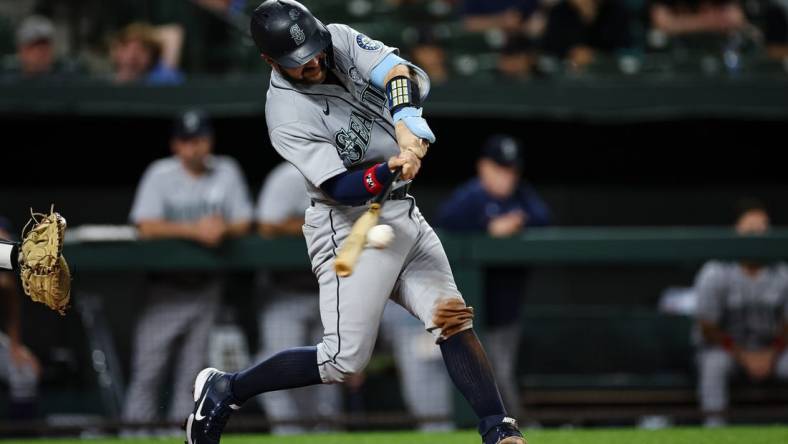 Jun 2, 2022; Baltimore, Maryland, USA; Seattle Mariners catcher Luis Torrens (22) hits a two RBI single against the Baltimore Orioles during the sixth inning at Oriole Park at Camden Yards. Mandatory Credit: Scott Taetsch-USA TODAY Sports