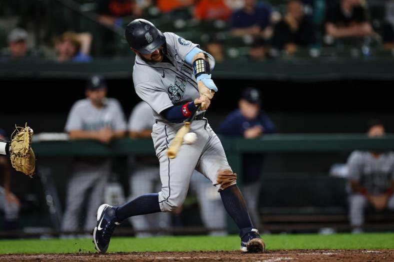 Jun 2, 2022; Baltimore, Maryland, USA; Seattle Mariners catcher Luis Torrens (22) hits a two RBI single against the Baltimore Orioles during the sixth inning at Oriole Park at Camden Yards. Mandatory Credit: Scott Taetsch-USA TODAY Sports