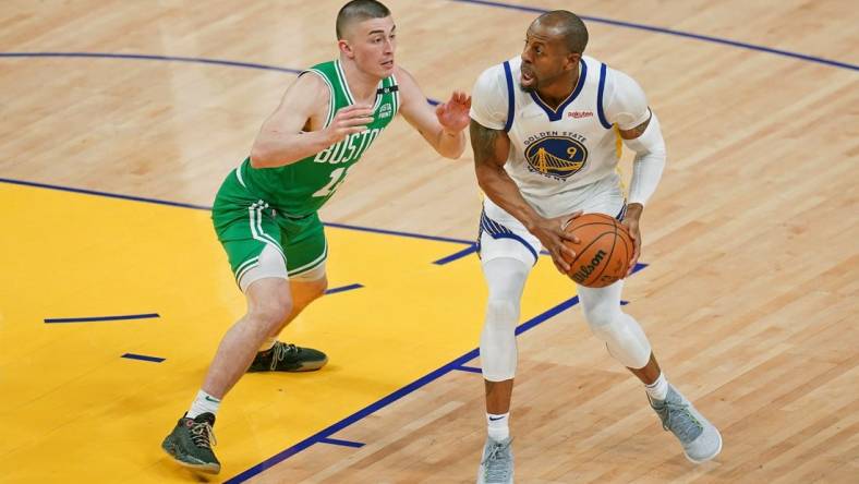 Jun 2, 2022; San Francisco, California, USA; Golden State Warriors forward Andre Iguodala (9) controls the ball while defended by Boston Celtics guard Payton Pritchard (11) during the second half of game one of the 2022 NBA Finals at Chase Center. Mandatory Credit: Cary Edmondson-USA TODAY Sports