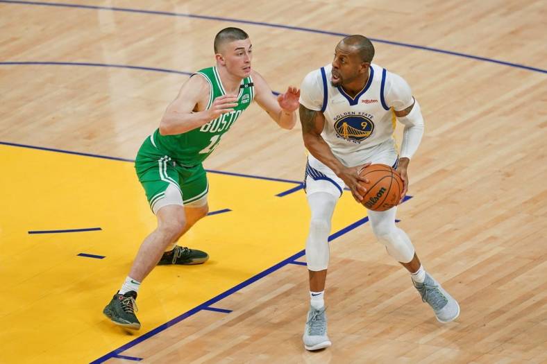 Jun 2, 2022; San Francisco, California, USA; Golden State Warriors forward Andre Iguodala (9) controls the ball while defended by Boston Celtics guard Payton Pritchard (11) during the second half of game one of the 2022 NBA Finals at Chase Center. Mandatory Credit: Cary Edmondson-USA TODAY Sports