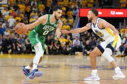 Jun 2, 2022; San Francisco, California, USA; Boston Celtics forward Jayson Tatum (0) dribbles the ball while defended by Golden State Warriors guard Stephen Curry (30) during the second half in game one of the 2022 NBA Finals at Chase Center. Mandatory Credit: Kyle Terada-USA TODAY Sports