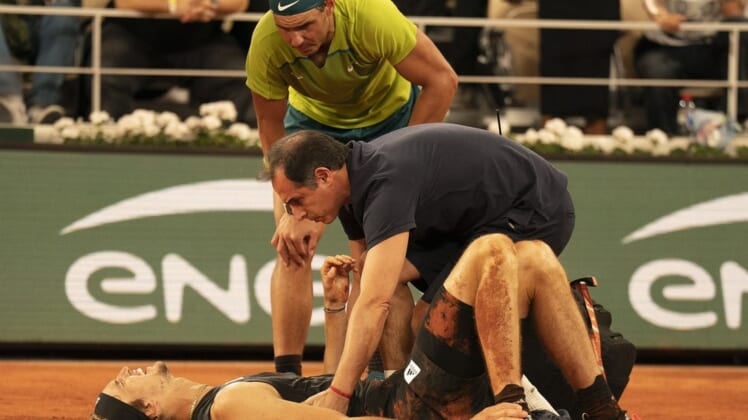 June 3, 2022; Paris, France; Alexander Zverev (GER) falls during his semifinal match against Rafael Nadal (ESP) and has to retire from the match on day 13 of the French Open at Stade Roland-Garros. He was taken from the court in a wheelchair and came back out with crutches to officially retire from the match. Mandatory Credit: Susan Mullane-USA TODAY Sports