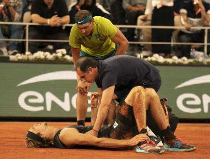 June 3, 2022; Paris, France; Alexander Zverev (GER) falls during his semifinal match against Rafael Nadal (ESP) and has to retire from the match on day 13 of the French Open at Stade Roland-Garros. He was taken from the court in a wheelchair and came back out with crutches to officially retire from the match. Mandatory Credit: Susan Mullane-USA TODAY Sports