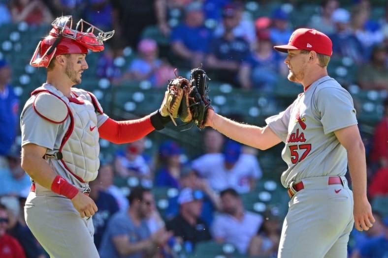 Jun 3, 2022; Chicago, Illinois, USA; St. Louis Cardinals catcher Andrew Knizner (7) and Zach Thompson (57) of the St. Louis Cardinals celebrate after securing the 14-5 win against the Chicago Cubs at Wrigley Field. Mandatory Credit: Quinn Harris-USA TODAY Sports