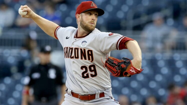 Jun 3, 2022; Pittsburgh, Pennsylvania, USA;  Arizona Diamondbacks starting pitcher Merrill Kelly (29) delivers a pitch against the Pittsburgh Pirates during the first inning at PNC Park. Mandatory Credit: Charles LeClaire-USA TODAY Sports
