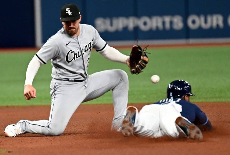 Jun 3, 2022; St. Petersburg, Florida, USA; Chicago White Sox shortstop Danny Mendick (20) drops the ball as Tampa Bay Rays third baseman Yandy Diaz (2) slides into second base in the fifth inning at Tropicana Field. Mandatory Credit: Jonathan Dyer-USA TODAY Sports