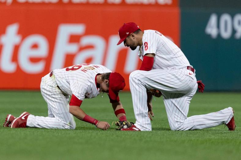 Jun 3, 2022; Philadelphia, Pennsylvania, USA; Philadelphia Phillies second baseman Nick Maton (29) is checked on by left fielder Nick Castellanos (8) after being shaken up on a diving play against the Los Angeles Angels during the sixth inning at Citizens Bank Park. Mandatory Credit: Bill Streicher-USA TODAY Sports