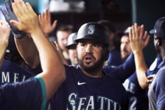 Jun 3, 2022; Arlington, Texas, USA; Seattle Mariners third baseman Eugenio Suarez (28) is greeted in the dugout after hitting an RBI sacrifice fly against the Texas Rangers during the fourth inning at Globe Life Field. Mandatory Credit: Raymond Carlin III-USA TODAY Sports