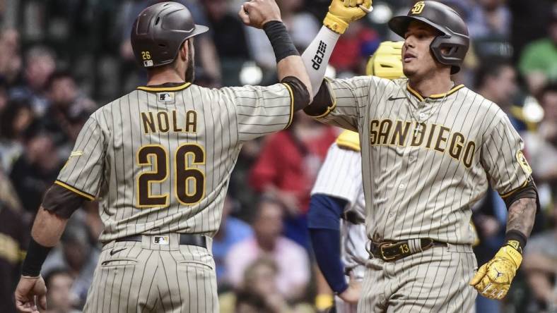 Jun 3, 2022; Milwaukee, Wisconsin, USA; San Diego Padres third baseman Manny Machado (13) celebrates with  catcher Austin Nola (26) after hitting a 3-run home run in the fourth inning against the Milwaukee Brewers at American Family Field. Mandatory Credit: Benny Sieu-USA TODAY Sports