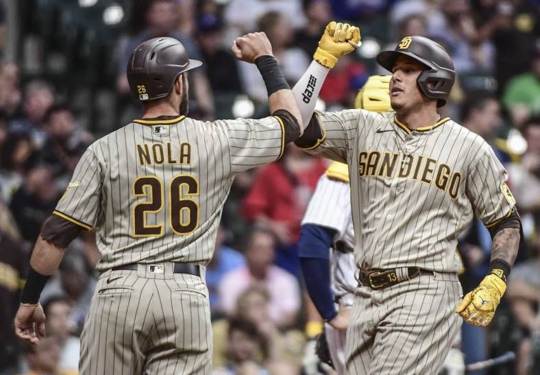 Jun 3, 2022; Milwaukee, Wisconsin, USA; San Diego Padres third baseman Manny Machado (13) celebrates with  catcher Austin Nola (26) after hitting a 3-run home run in the fourth inning against the Milwaukee Brewers at American Family Field. Mandatory Credit: Benny Sieu-USA TODAY Sports