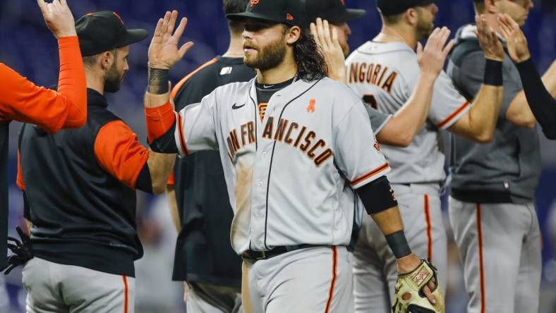 Jun 3, 2022; Miami, Florida, USA; San Francisco Giants shortstop Brandon Crawford (35) celebrates with teammates after winning the game against the Miami Marlins at loanDepot Park. Mandatory Credit: Sam Navarro-USA TODAY Sports