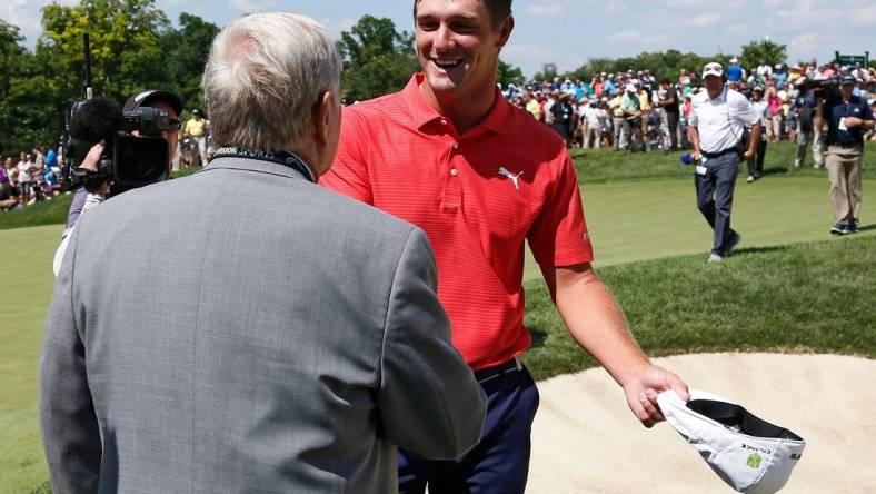 Bryson DeChambeau shakes hands with Jack Nicklaus following his playoff win in the final round of the Memorial Tournament at Muirfield Village Golf Club in Dublin, Ohio on June 3, 2018. DeChambeau won the tournament in a two-hole playoff. [Adam Cairns / Dispatch]