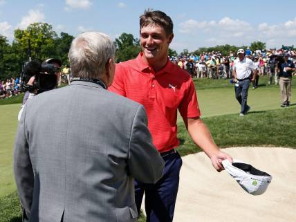 Bryson DeChambeau shakes hands with Jack Nicklaus following his playoff win in the final round of the Memorial Tournament at Muirfield Village Golf Club in Dublin, Ohio on June 3, 2018. DeChambeau won the tournament in a two-hole playoff. [Adam Cairns / Dispatch]