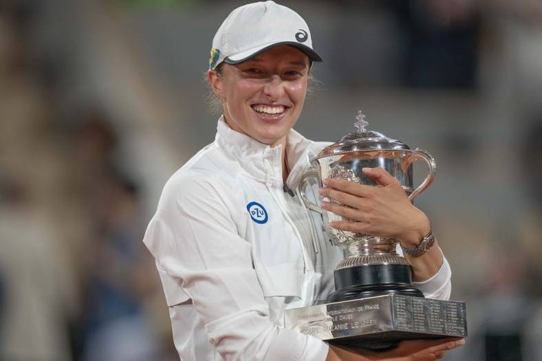 June 4, 2022; Paris, France; Iga Swiatek (POL) poses with the trophy after winning the women's singles final against Coco Gauff (USA) on day 14 of the French Open at Stade Roland-Garros. Mandatory Credit: Susan Mullane-USA TODAY Sports