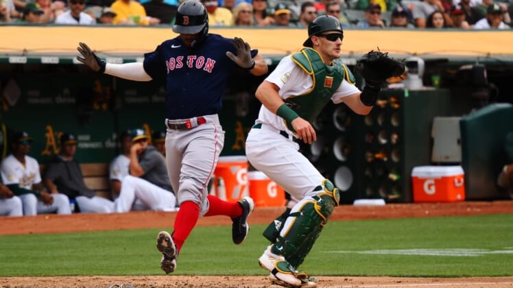 Jun 4, 2022; Oakland, California, USA; Boston Red Sox shortstop Xander Bogaerts (2) scores a run behind Oakland Athletics catcher Sean Murphy (12) during the fourth inning at RingCentral Coliseum. Mandatory Credit: Kelley L Cox-USA TODAY Sports