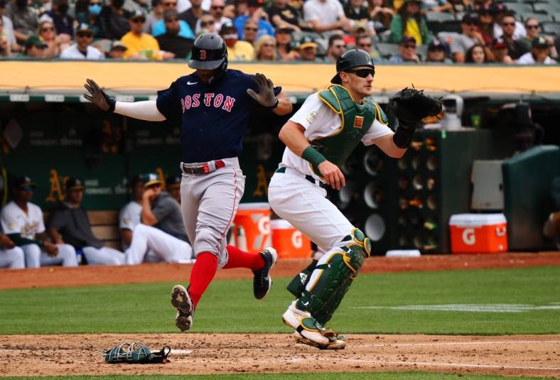 Jun 4, 2022; Oakland, California, USA; Boston Red Sox shortstop Xander Bogaerts (2) scores a run behind Oakland Athletics catcher Sean Murphy (12) during the fourth inning at RingCentral Coliseum. Mandatory Credit: Kelley L Cox-USA TODAY Sports