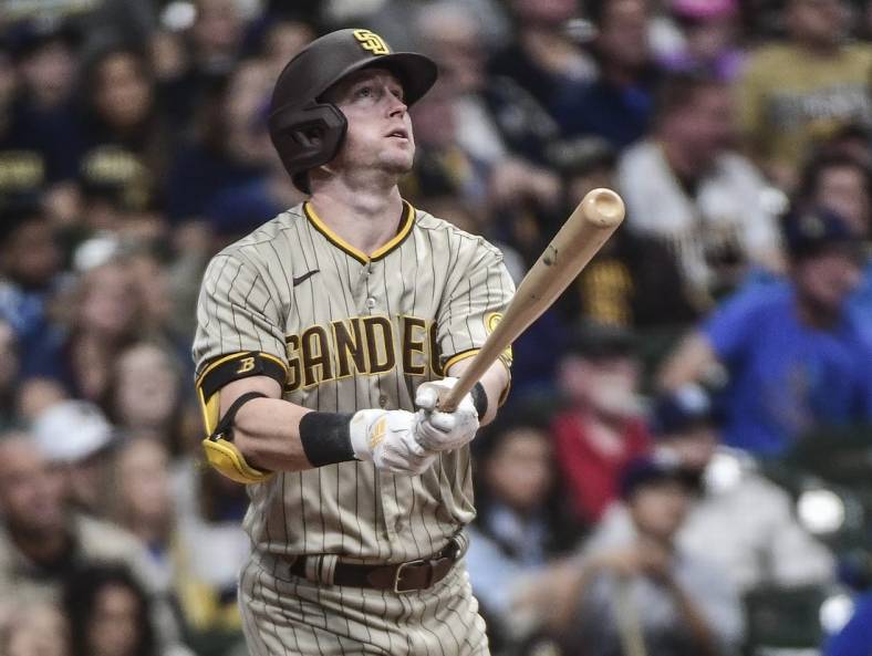 Jun 4, 2022; Milwaukee, Wisconsin, USA; San Diego Padres first baseman Jake Cronenworth (9) watches after hitting a two-run homer in the fifth inning during game against the Milwaukee Brewers at American Family Field. Mandatory Credit: Benny Sieu-USA TODAY Sports