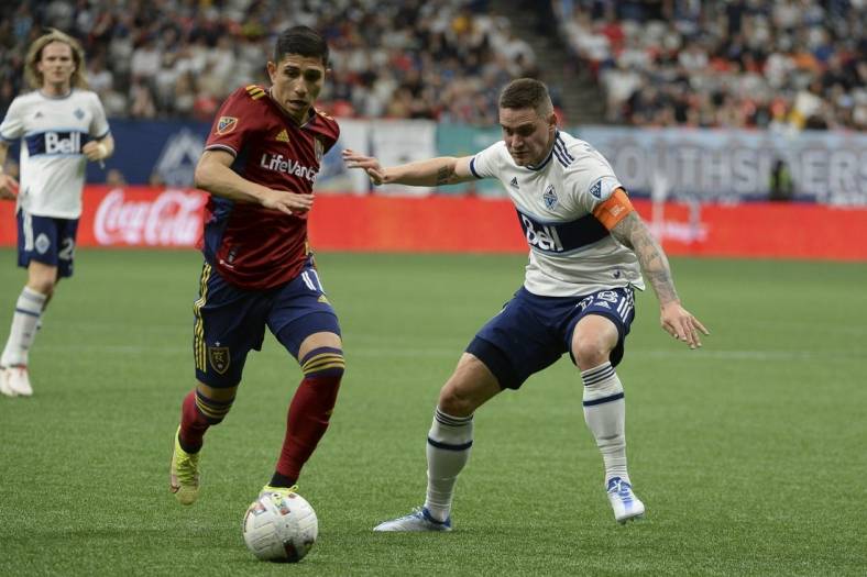 Jun 4, 2022; Vancouver, British Columbia, CAN;  Real Salt Lake forward Jefferson Savarino (11) dribbles the ball against Vancouver Whitecaps defender Jake Nerwinski (28) during the second half at BC Place. Mandatory Credit: Anne-Marie Sorvin-USA TODAY Sports