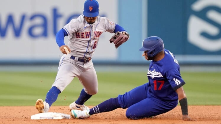 Jun 4, 2022; Los Angeles, California, USA; Los Angeles Dodgers third baseman Hanser Alberto (17) slides into second base to beat a throw to New York Mets shortstop Francisco Lindor (12) in the second inning at Dodger Stadium. Mandatory Credit: Kirby Lee-USA TODAY Sports
