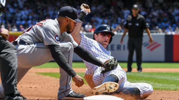 Jun 5, 2022; Bronx, New York, USA;  Detroit Tigers shortstop Harold Castro (30) tags out New York Yankees second baseman DJ LeMahieu (26) at third base during the third inning at Yankee Stadium. Mandatory Credit: Dennis Schneidler-USA TODAY Sports