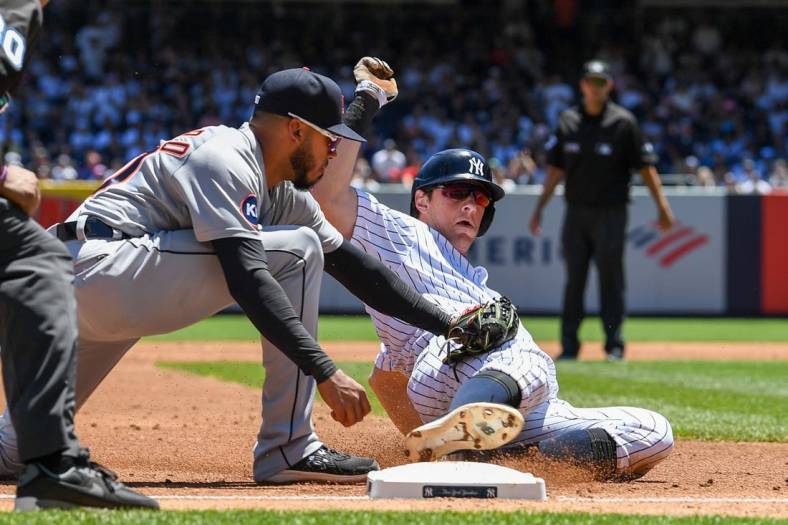 Jun 5, 2022; Bronx, New York, USA;  Detroit Tigers shortstop Harold Castro (30) tags out New York Yankees second baseman DJ LeMahieu (26) at third base during the third inning at Yankee Stadium. Mandatory Credit: Dennis Schneidler-USA TODAY Sports